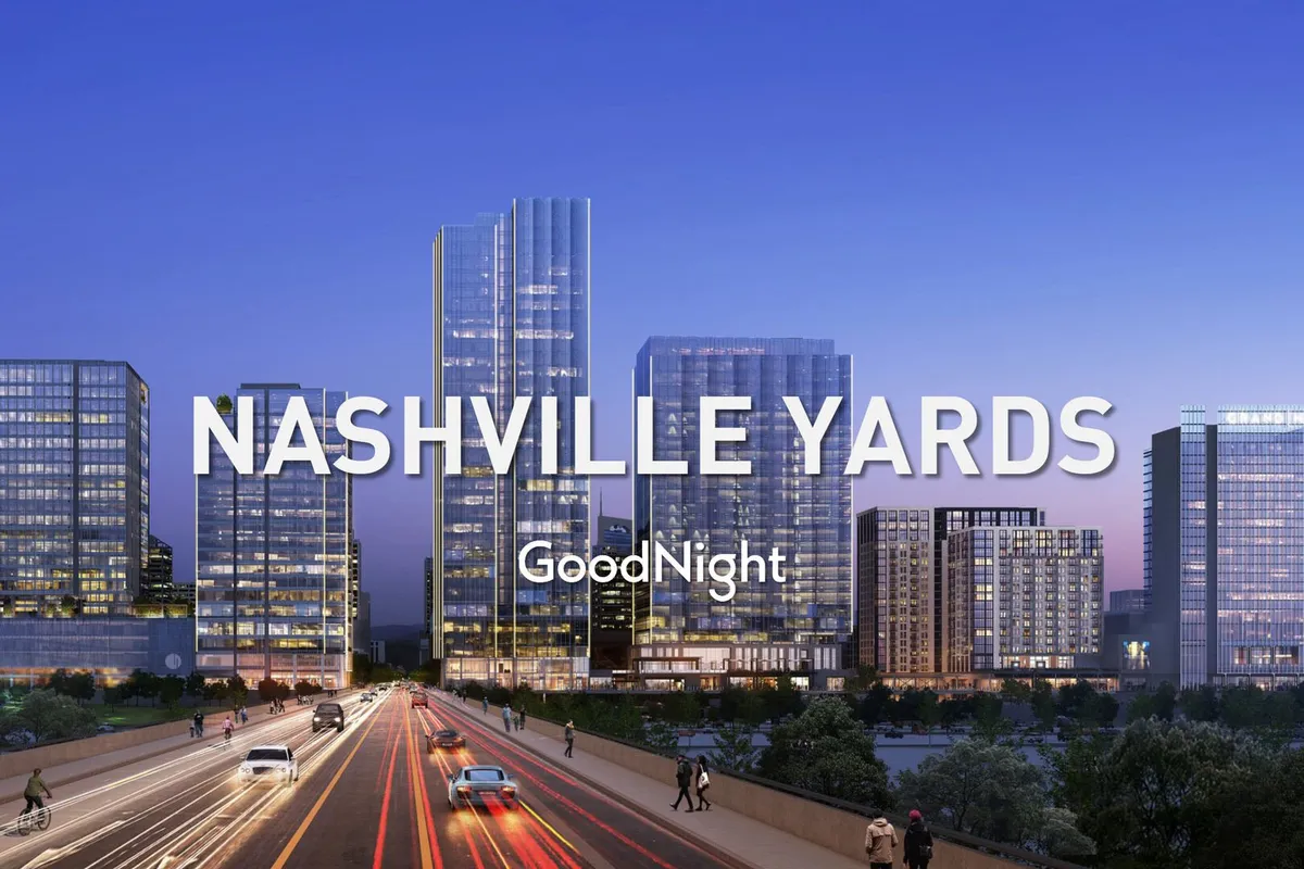 A vibrant exterior shot of central Nashville, featuring tall skyscrapers, an urban landscape, and a main road illuminated by street lights. The scene buzzes with energy, suggesting the city's lively nightlife and diverse attractions within easy reach.